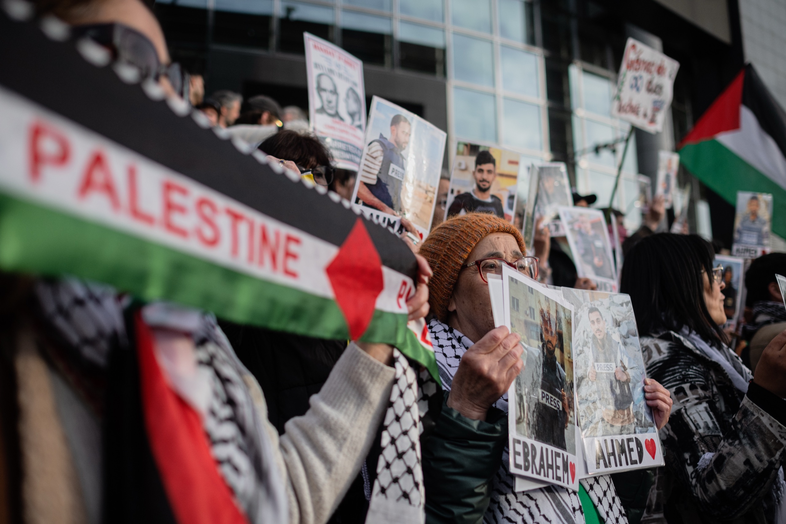 Mourners hold portraits of journalists killed in Gaza